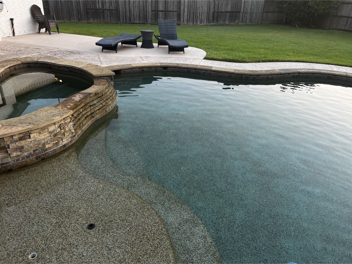 Large backyard pool with sparkling water after a Clean Pool Squad service