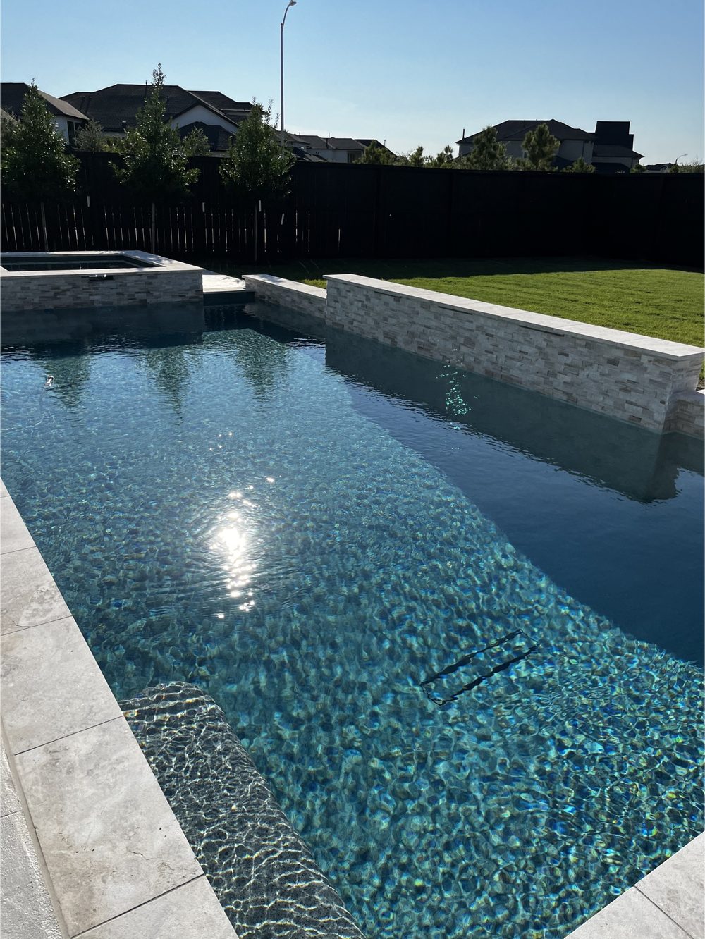 Pool and spa with clear balanced water in West Lake Hills, TX