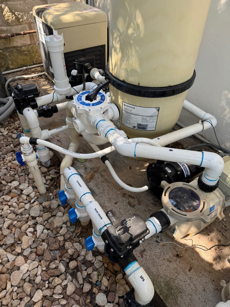 Pool pump and filter plumbing being repaired at an equipment pad in Dripping Springs